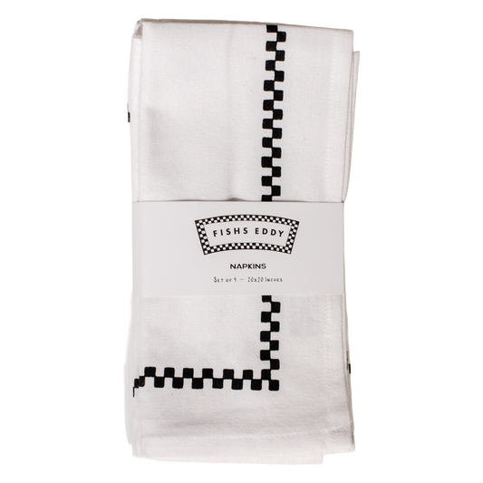 Folded white napkins with black checkered pattern and 'Fishs Eddy' branding on a white background