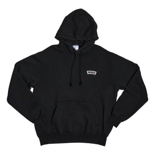 Black hoodie with a small white logo on a white background