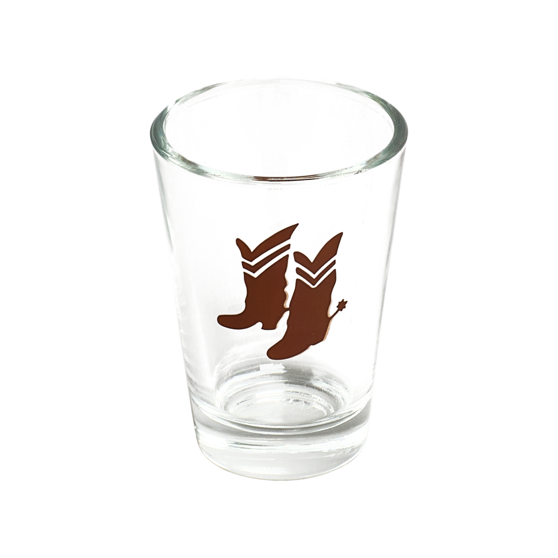 Clear glass shot glass with brown boot design on a white background