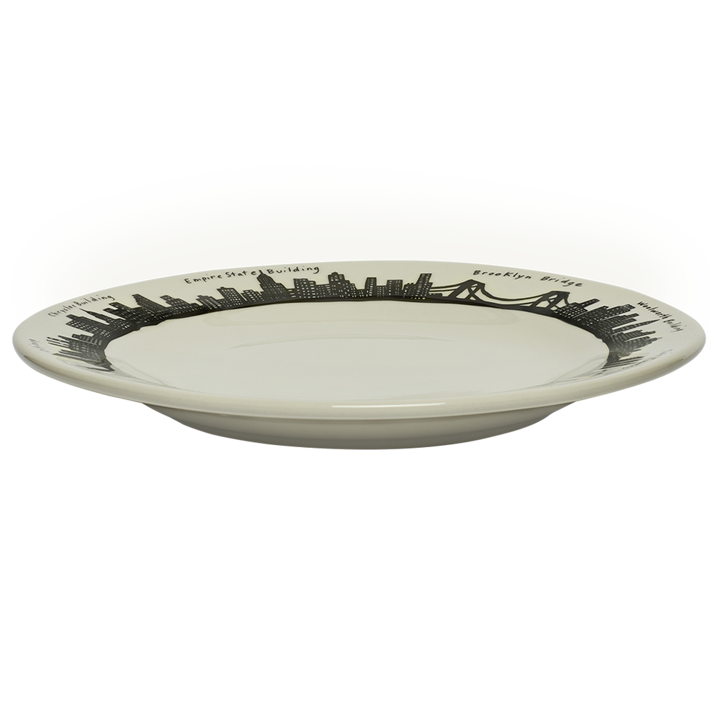 White ceramic plate with black city skyline design on a white background