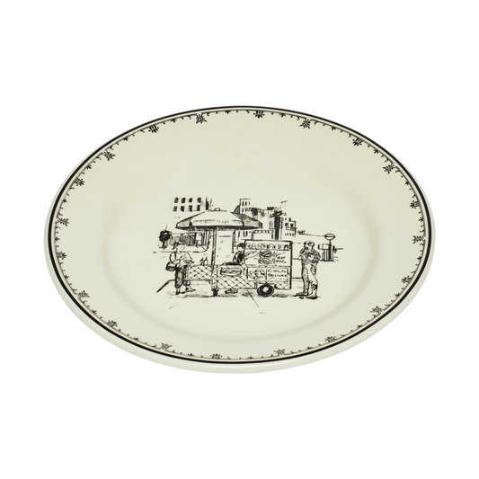 Round ceramic plate with black decorative design on a white background