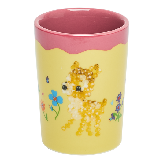 Yellow tumbler with a deer design and pink rim on a white background