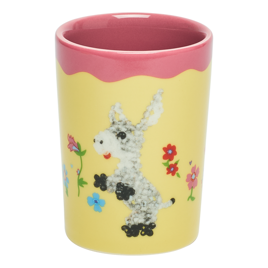 Yellow cup with pink rim featuring a cartoon donkey and flowers on a white background