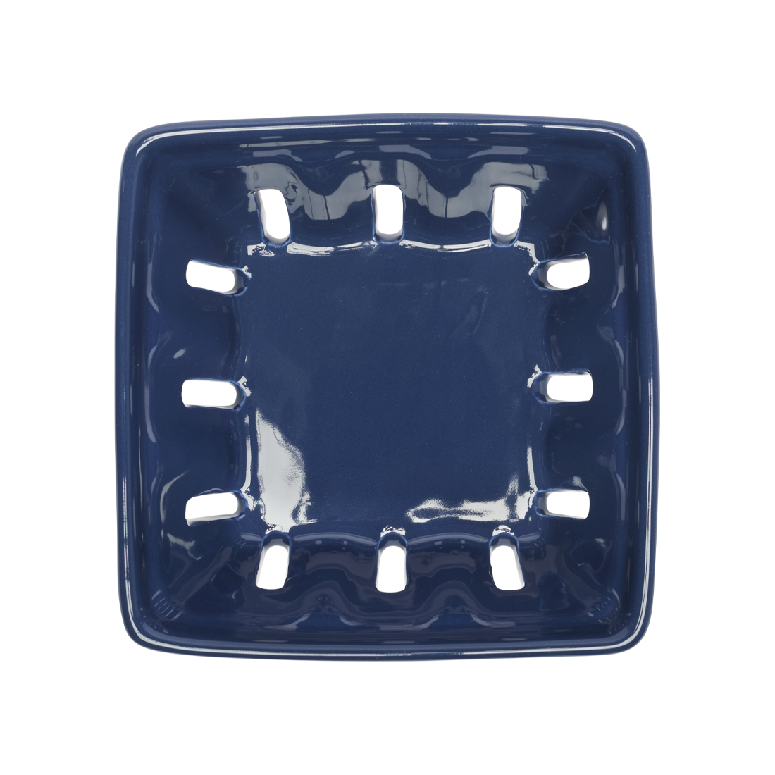 Blue ceramic soap dish with decorative holes on a white background