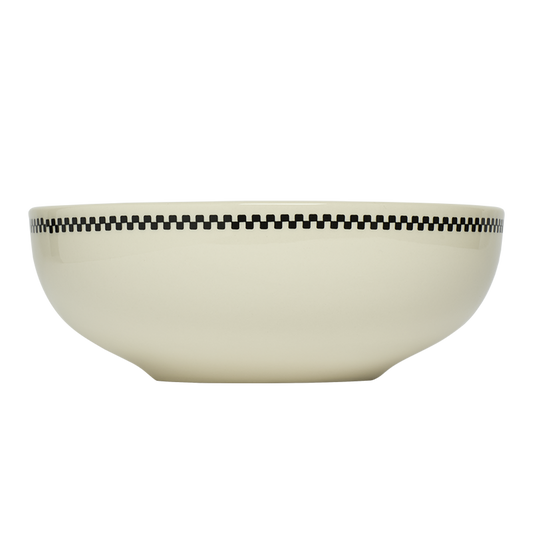 Beige bowl with black checkered pattern on a white background