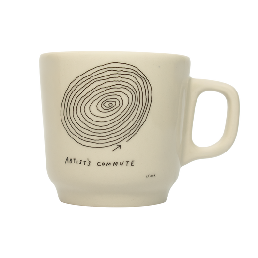 A white ceramic mug with a hand-drawn spiral and the text 'ARTIST'S COMMUTE' on the side.