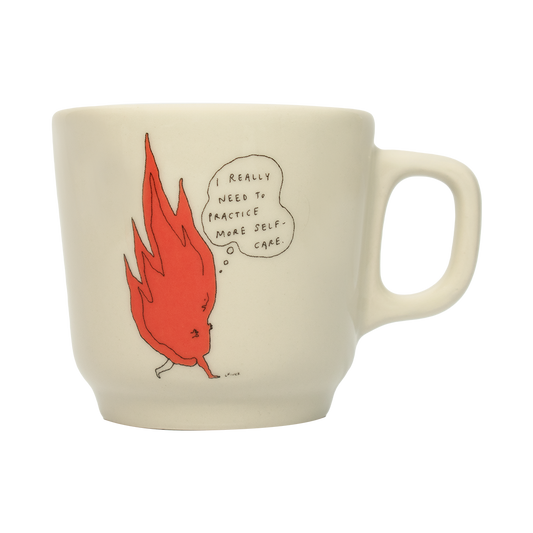 A white ceramic mug with an orange and black illustration of a cartoon character and text that reads 'Really need to practice self-care today.'.