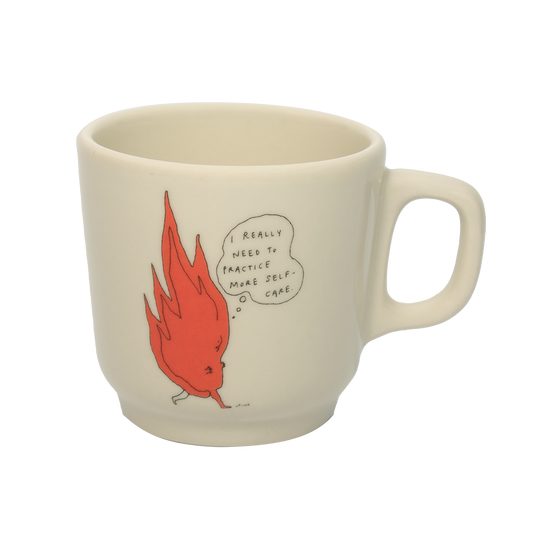 A white ceramic mug with an orange and black illustration of a cartoon character and text that reads 'Really need to practice self-care today.'.