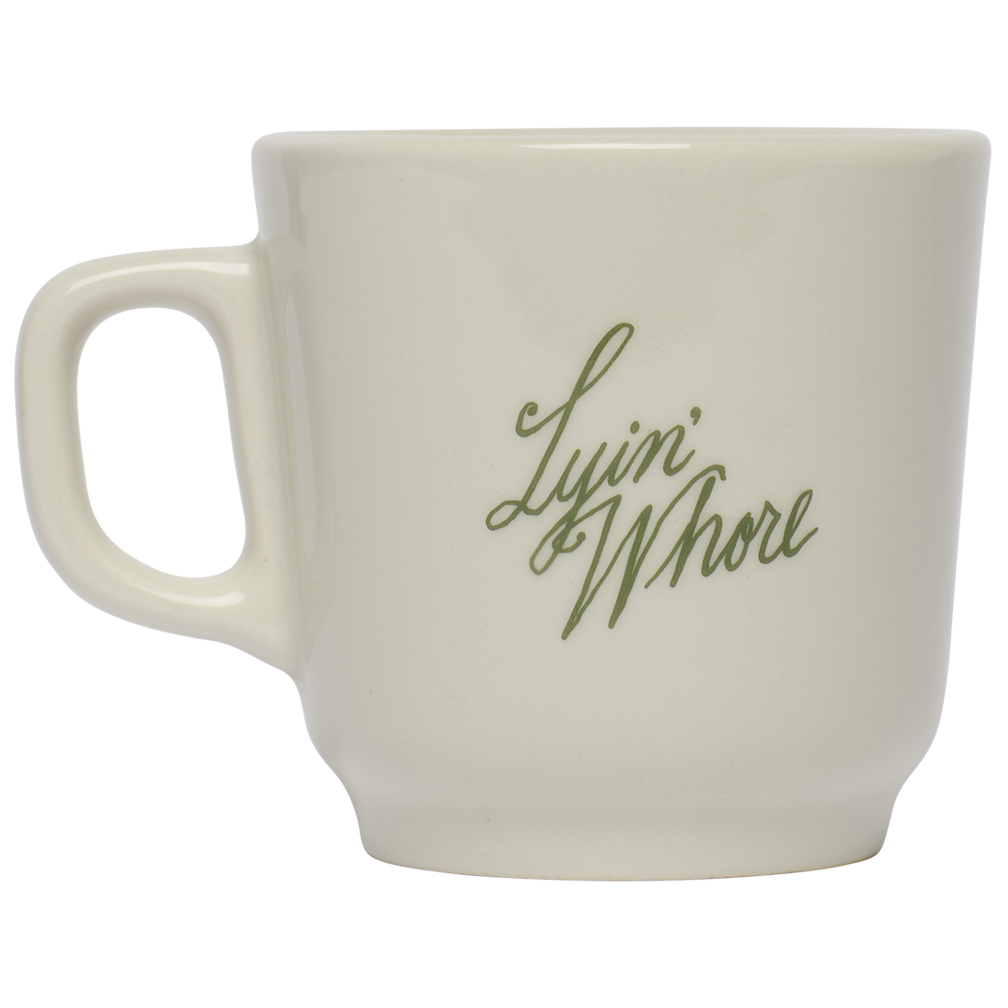 White mug with green text on a white background