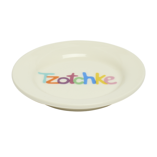 Round beige plate with 'Tzotchke' in colorful letters on a white background