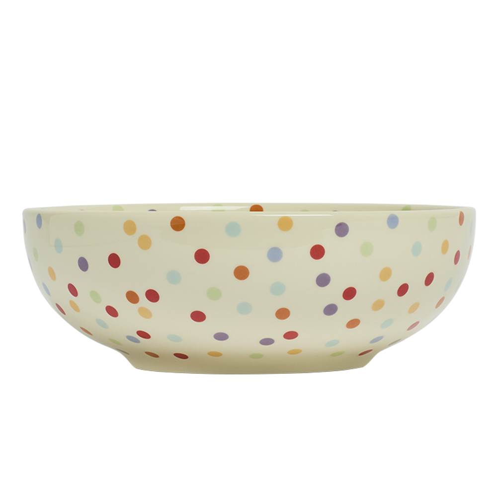 Ceramic bowl with colorful polka dot pattern on a white background