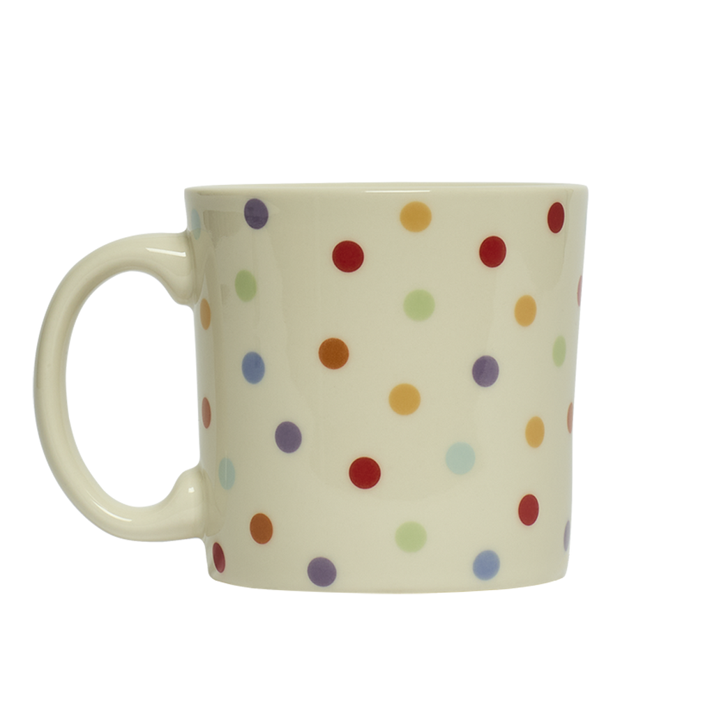 White mug with colorful polka dot pattern on a white background