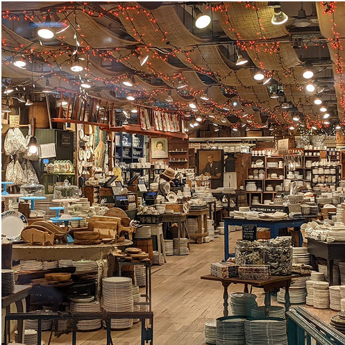 Interior of a store with various products and string lights.