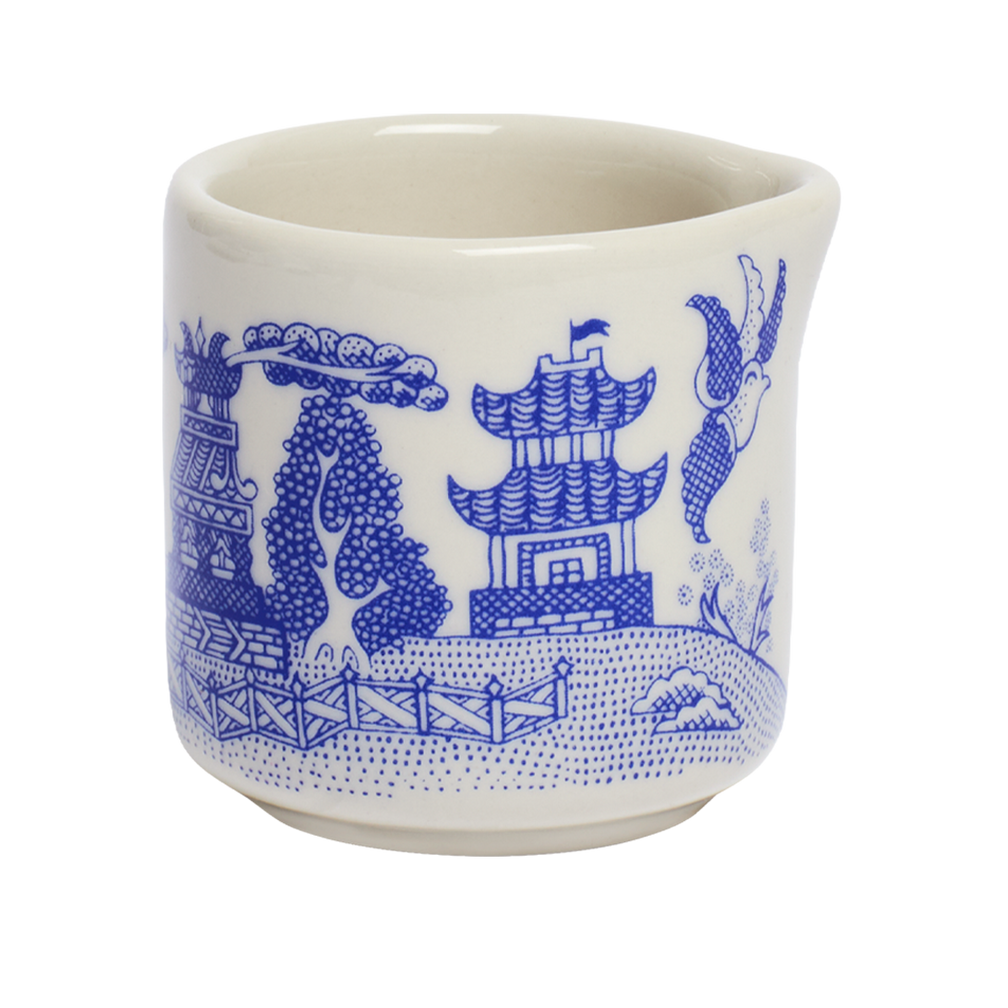 White ceramic cup with blue decorative patterns on a white background
