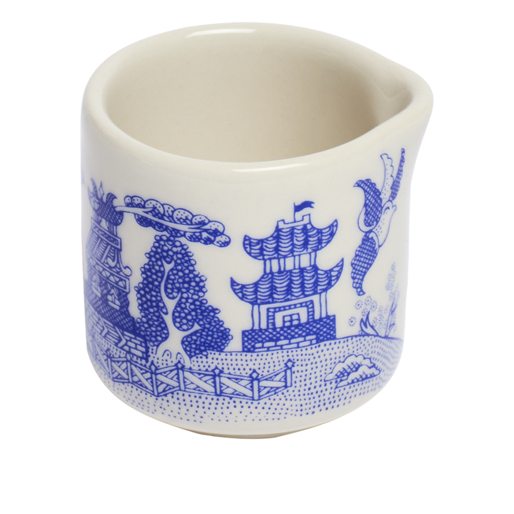 White ceramic cup with blue decorative elements on a white background