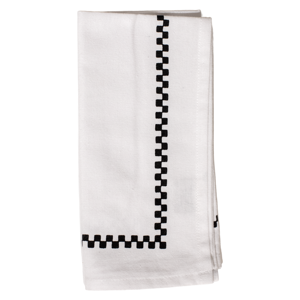 White towel with black checkered border on a white background