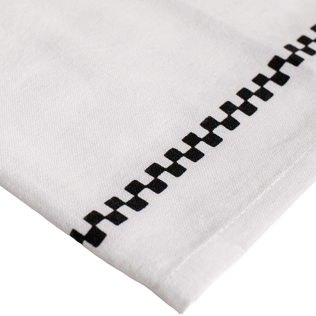 White fabric with black geometric pattern on a white background