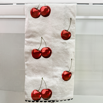 Towel with red cherry pattern hanging on a rack