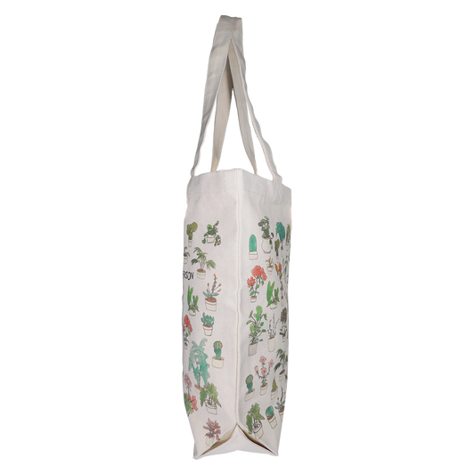 A beige tote bag with a pattern of various plants and the text 'PLANT PERSON' across the bottom.