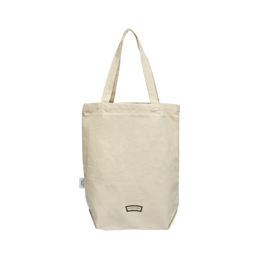 Beige tote bag with a small logo on a white background