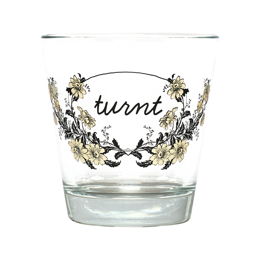 Clear glass with floral design and 'turnt' text on a white background