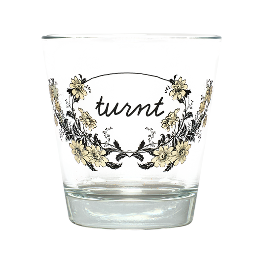 Clear glass with floral design and 'turnt' text on a white background