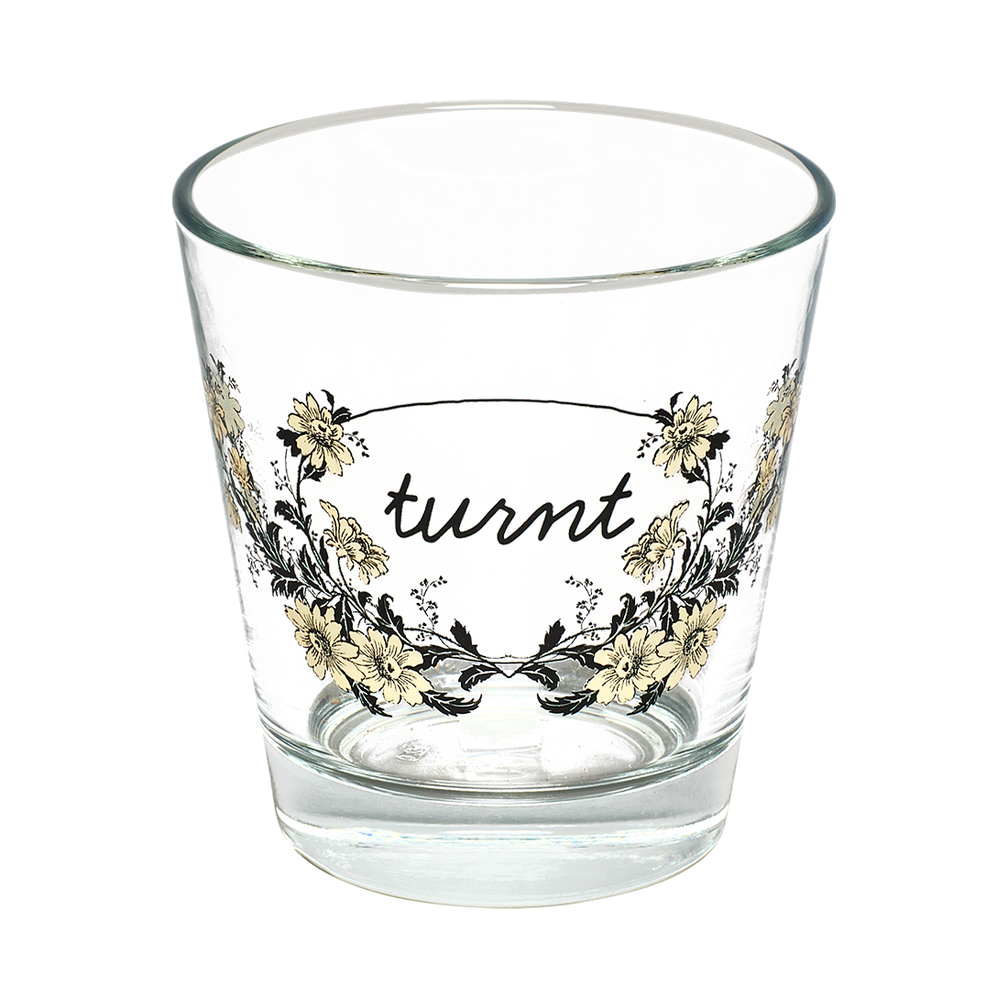 Clear glass with floral design and 'turnt' text on a white background