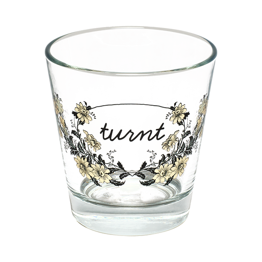 Clear glass with floral design and 'turnt' text on a white background