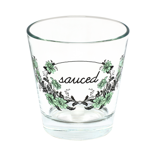 Clear glass with 'sauced' text and floral design on a white background