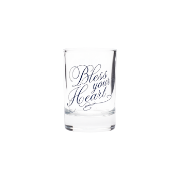 Clear shot glass with blue script lettering that reads “Bless your Heart.”