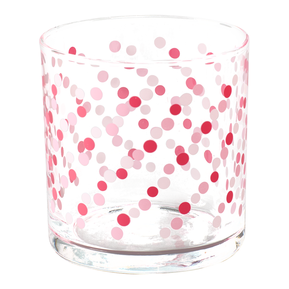 Clear glass tumbler with pink and red polka dot pattern on a white background