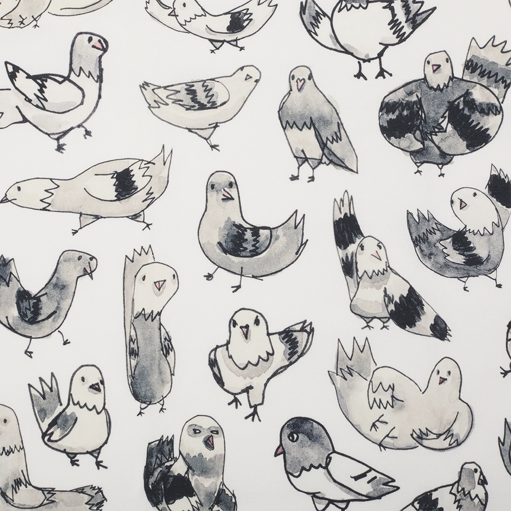 Close up of a white tea towel covered in whimsical gray and black hand-drawn NYC pigeon