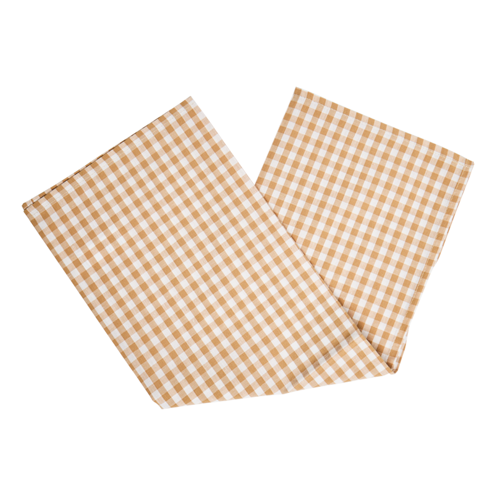 Two brown and white checkered placemats on a white background