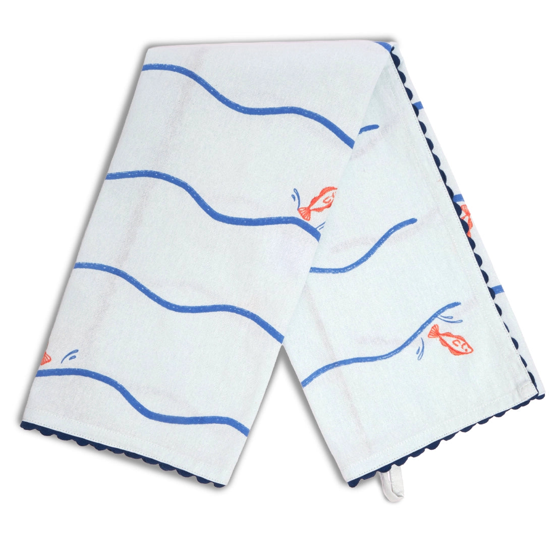 Pale blue fish and waves tea towel draped in an inverted V shape, featuring blue wavy stripes, scattered orange fish illustrations, and dark blue scalloped edging.