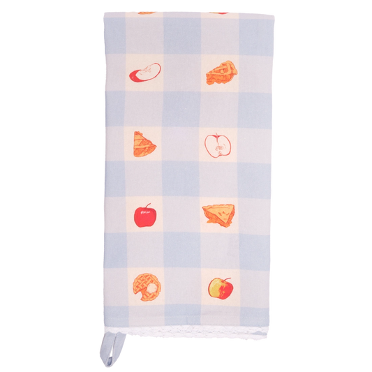Light blue and white gingham tea towel folded lengthwise and shown vertically, featuring small red apples and golden apple pie illustrations in alternating checks, with white lace trim.