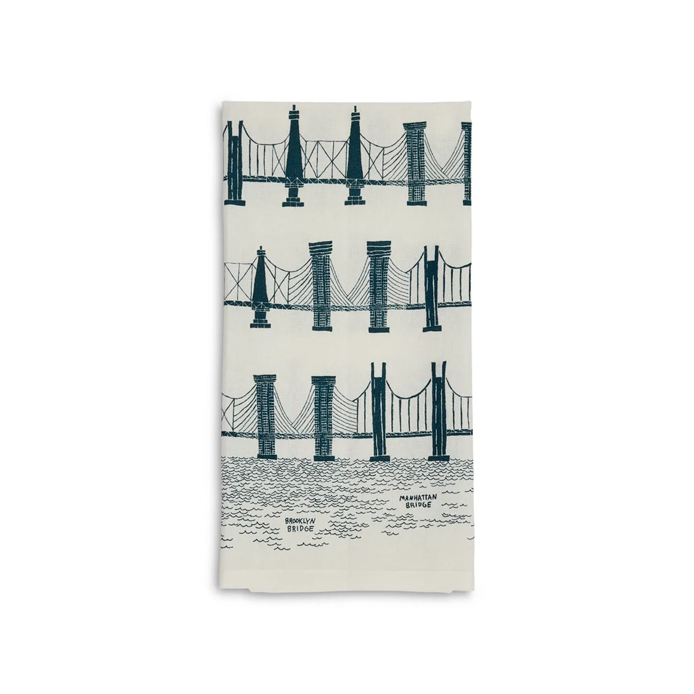Folded cream tea towel with rows of teal suspension bridge illustrations