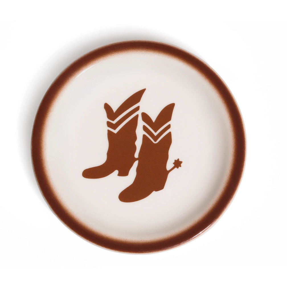 Cream glazed ceramic plate with a warm brown airbrushed rim and centered cowboy boots graphic with a spur; a playful Western accent for serving snacks, sides, or dessert.