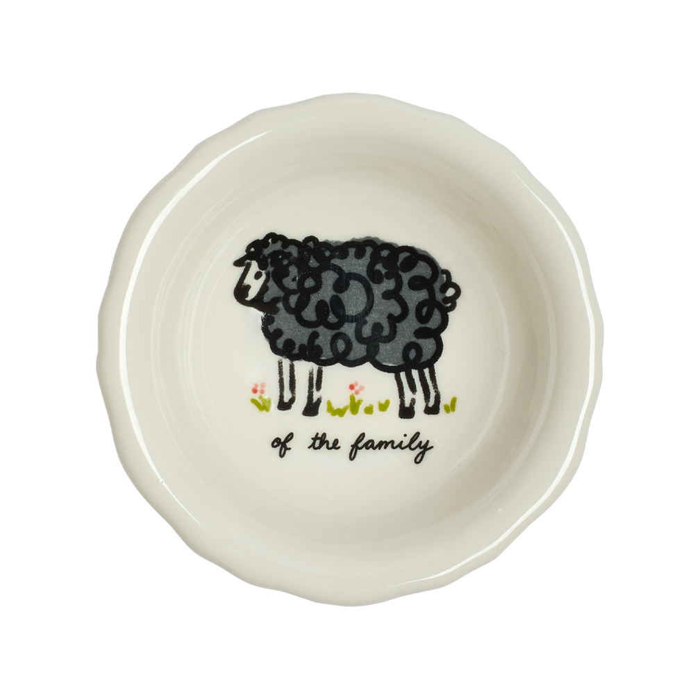 White ceramic plate with a black sheep illustration and text on a white background