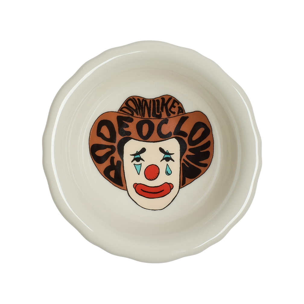 Ceramic bowl with clown face design on a white background