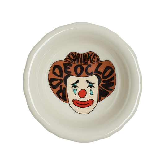 Ceramic bowl with clown face design on a white background