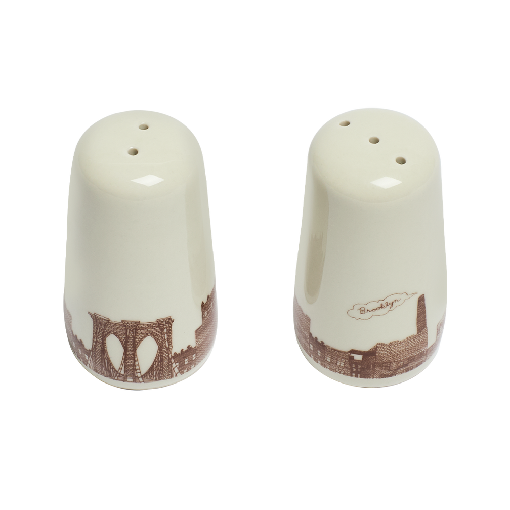 Two ceramic salt and pepper shakers with decorative designs on a white background