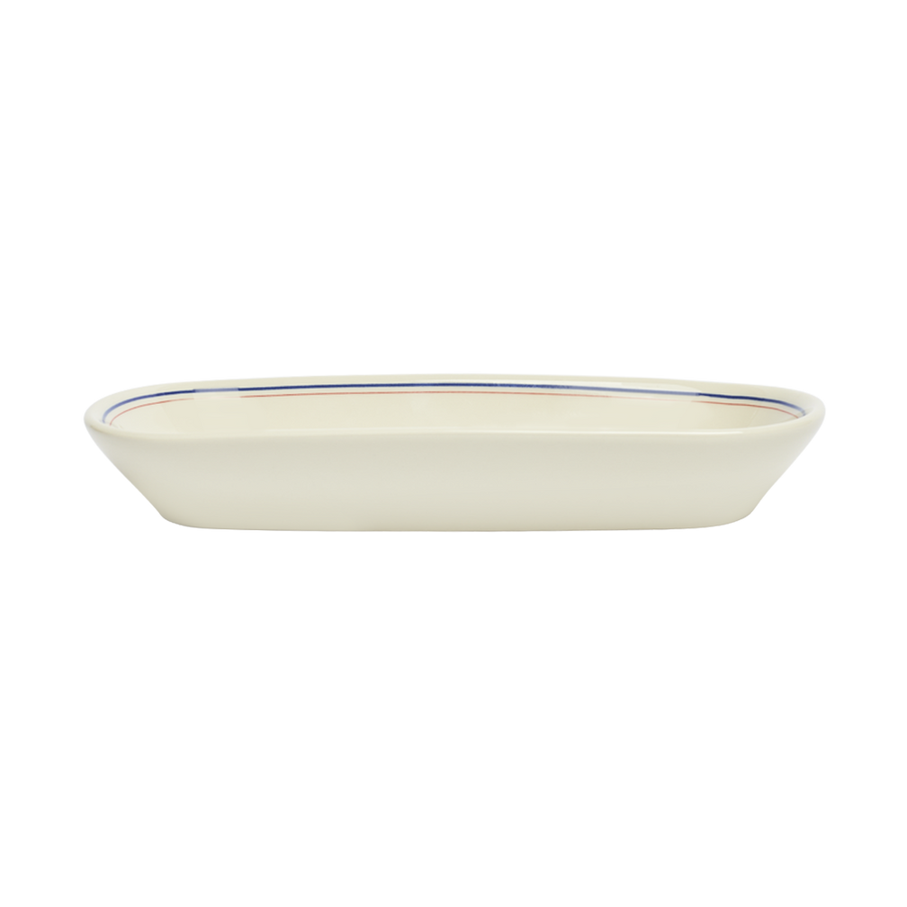 White ceramic dish with blue rim on a white background