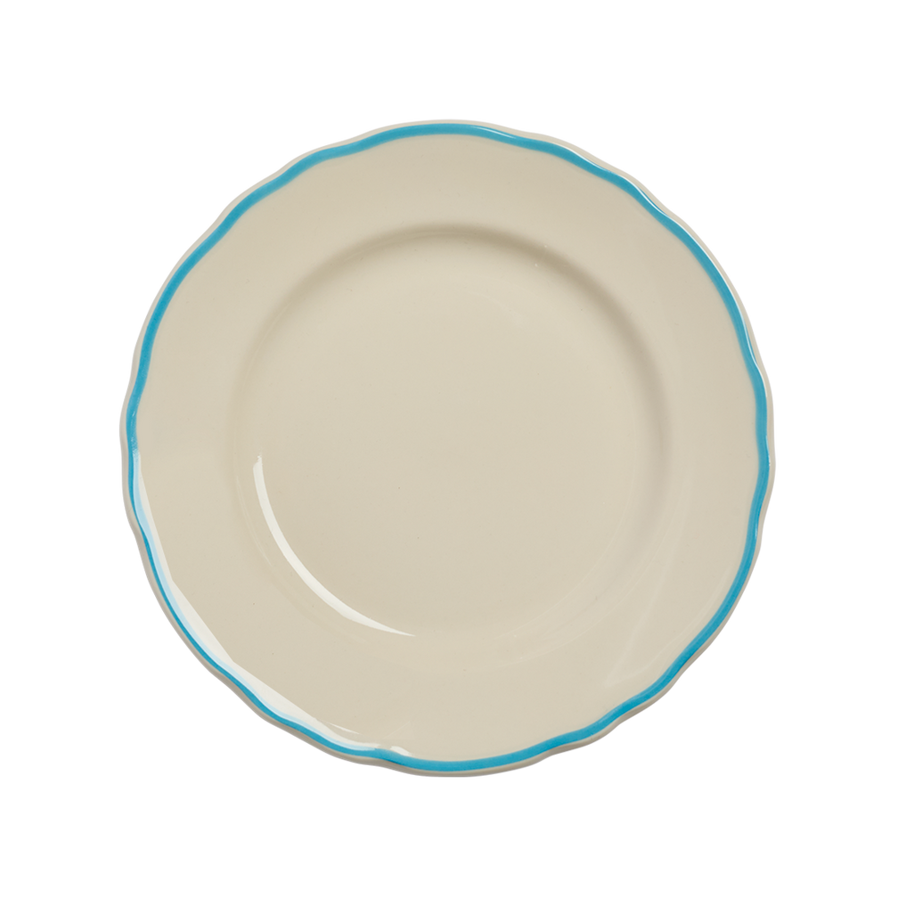 Beige ceramic plate with a blue rim on a white background