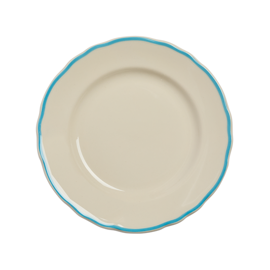 Beige ceramic plate with a blue rim on a white background