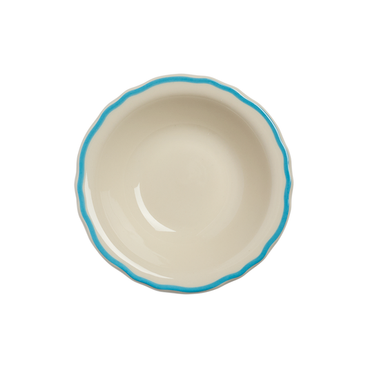 Ceramic bowl with blue rim on a white background