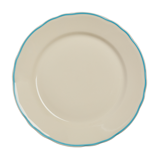 Beige ceramic plate with a blue rim on a white background