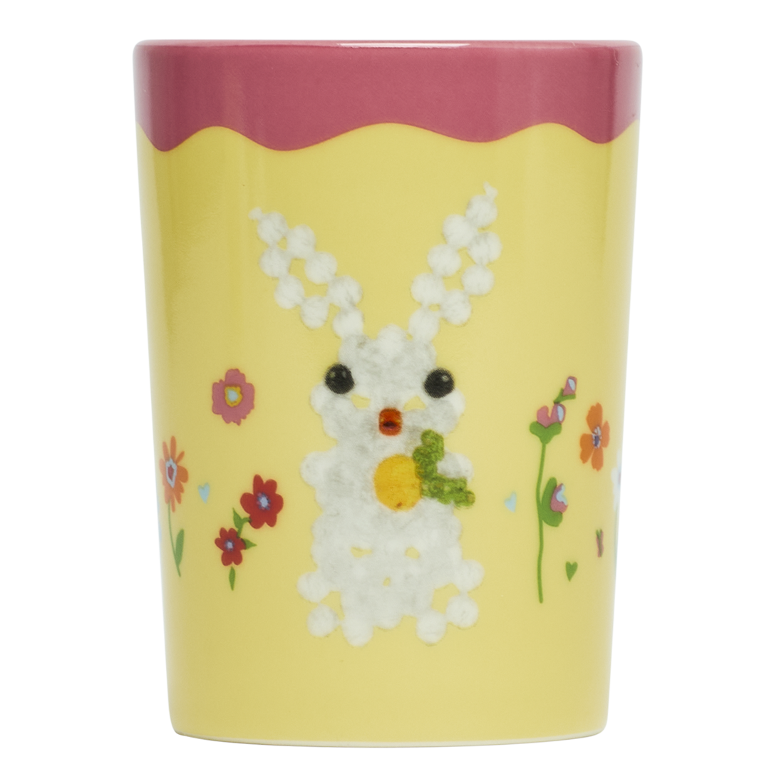 Decorative cup with a bunny design on a yellow background