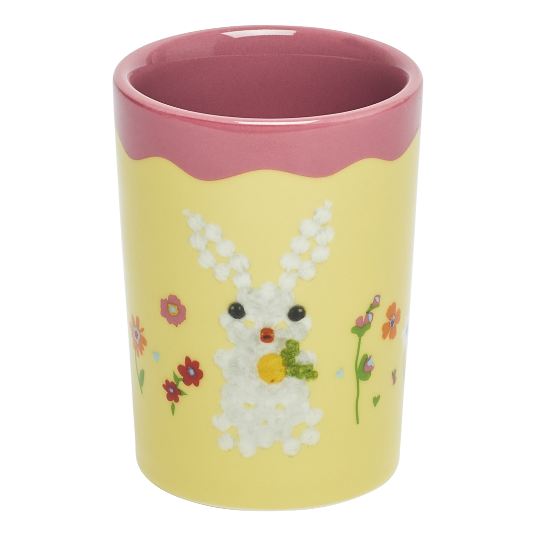 Yellow cup with a rabbit design and pink rim on a white background