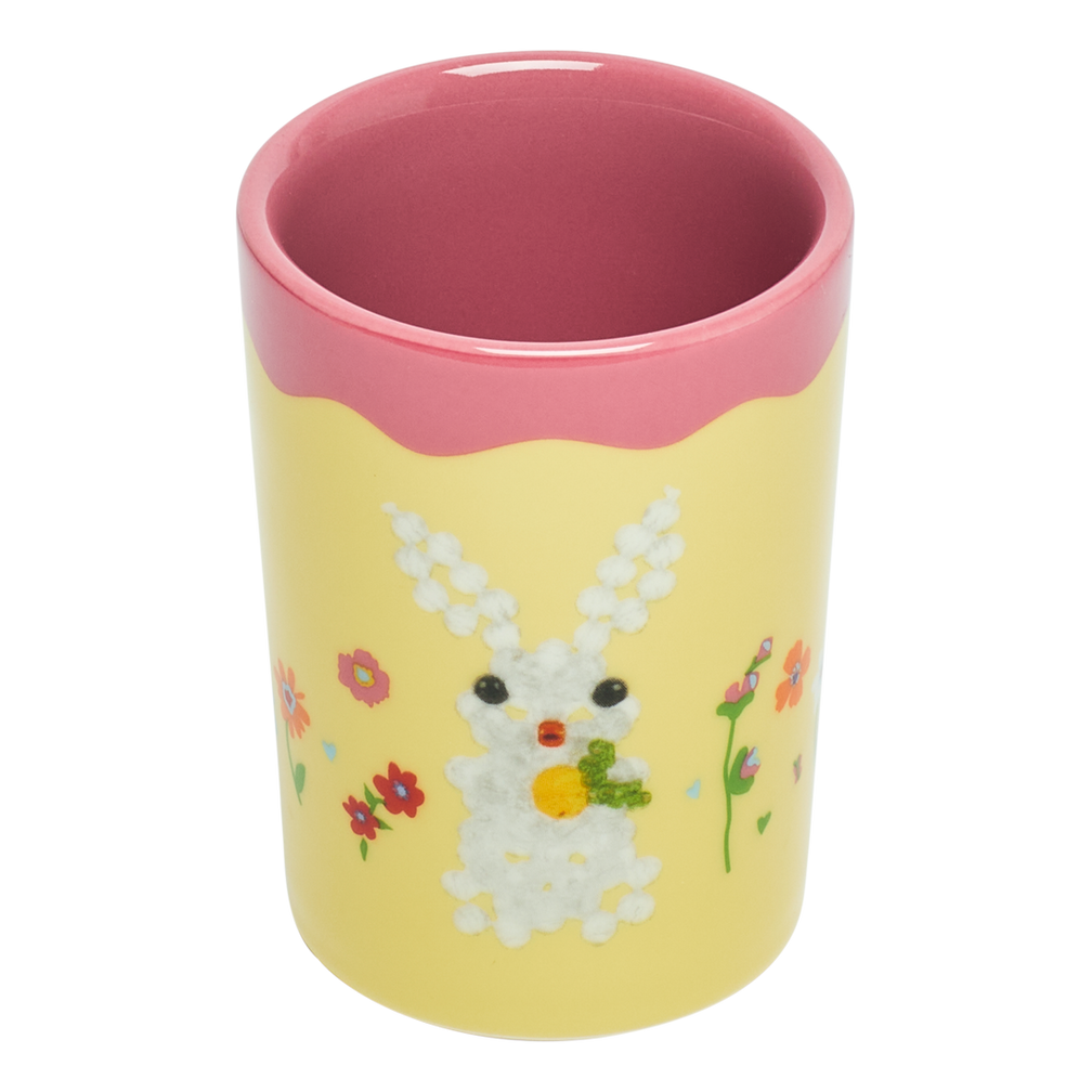 Yellow tumbler with a pink rim featuring a bunny design on a white background