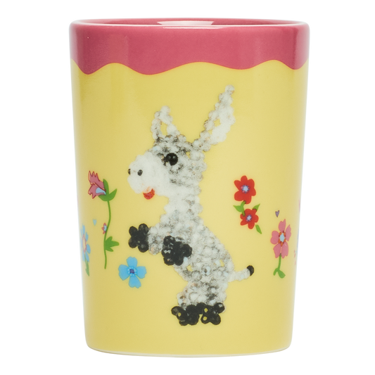 Mug with a donkey design and colorful flowers on a yellow background
